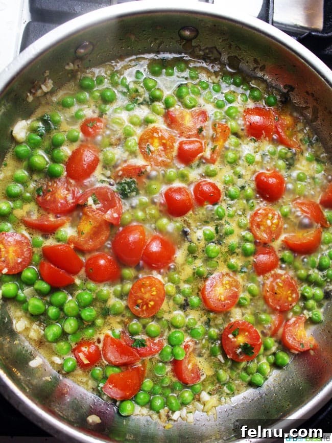 Wine-Poached Halibut: A Simple Seafood Delight 5 Wild Alaskan Halibut Poached with Tomatoes and Peas Wine Sauce, recipe on UrbanBlissLife.com
