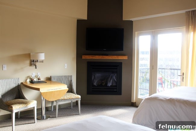 The spacious and well-appointed guest room at the Inn at the 5th, featuring comfortable seating and elegant decor.