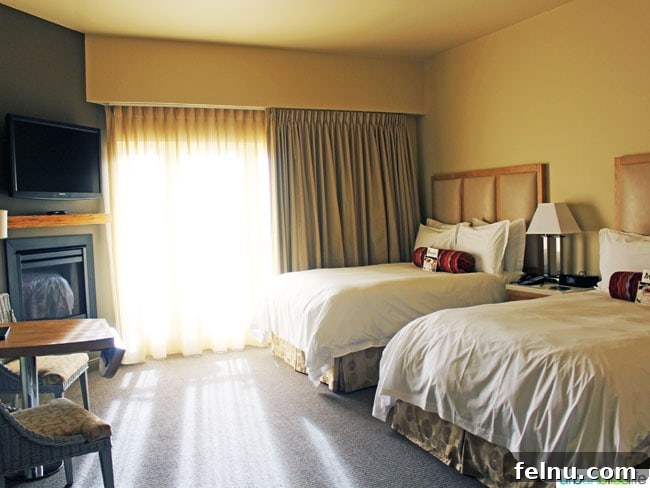Another view of the guest room at the Inn at the 5th, highlighting the plush bedding and elegant furnishings.