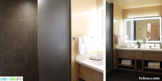 The modern and spacious bathroom at the Inn at the 5th, featuring a double sink vanity and ample counter space.