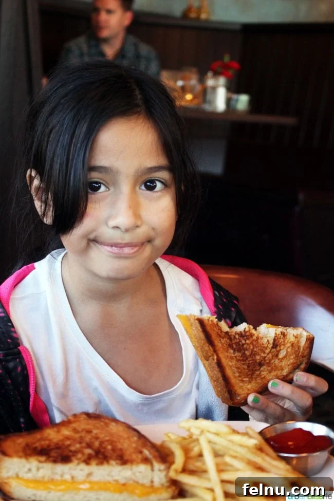 Dining at The Wayfarer Cannon Beach's Iconic Eatery 10 Child enjoying Cheezer Pleezer grilled cheese at Wayfarer Restaurant