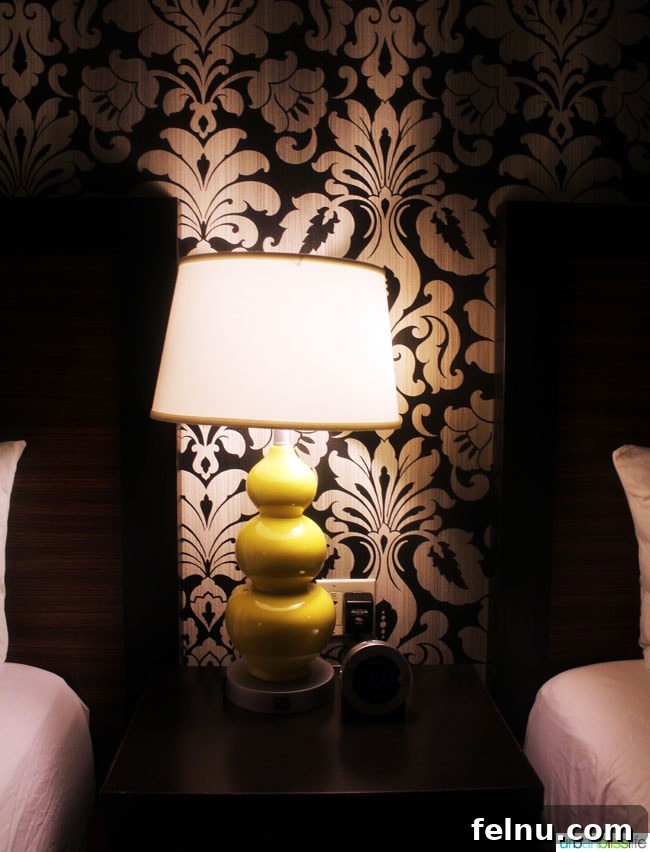 A stylish lamp on a nightstand in a guest room at The Maxwell Hotel Seattle, highlighting the hotel's attention to detail.