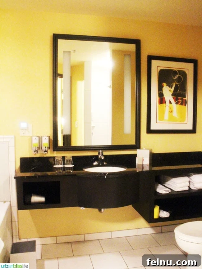 The spacious bathroom in the Prima Donna Suite at The Maxwell Hotel Seattle, featuring a jetted tub and a walk-in shower.