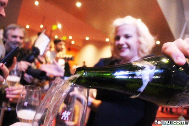 Seattle Wine and Food Experience: POP! Bubbles and Seafood 13 Champagne flowing after a successful saber attempt at the POP! event.