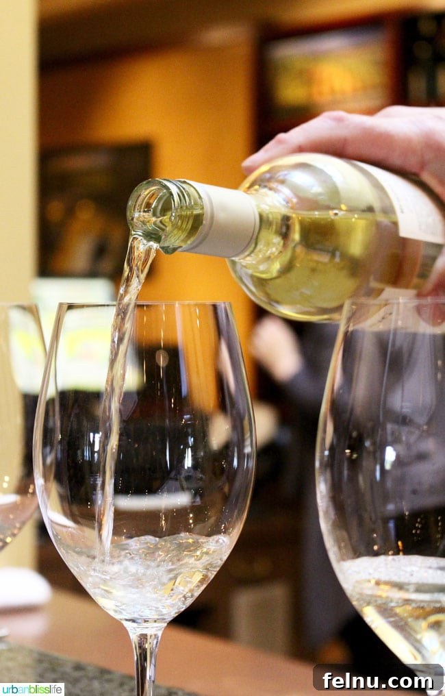 Rodney Strong Vineyards Your Sonoma Wine Escape 20 White wine being poured into a tall glass at a tasting event
