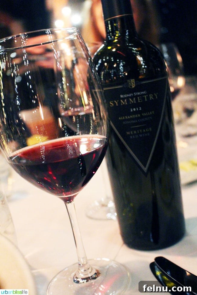 Rodney Strong Vineyards Your Sonoma Wine Escape 9 Glass of red wine beside a bottle of Rodney Strong Symmetry on a white tablecloth
