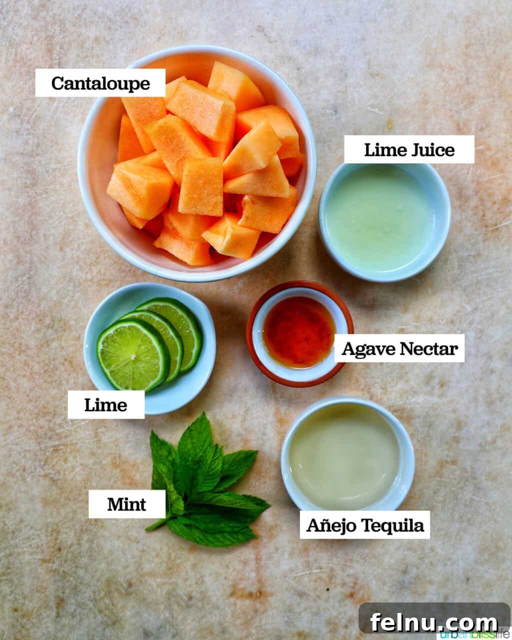 Ingredients in bowls to make cantaloupe melon margarita cocktails on a yellow faded background.