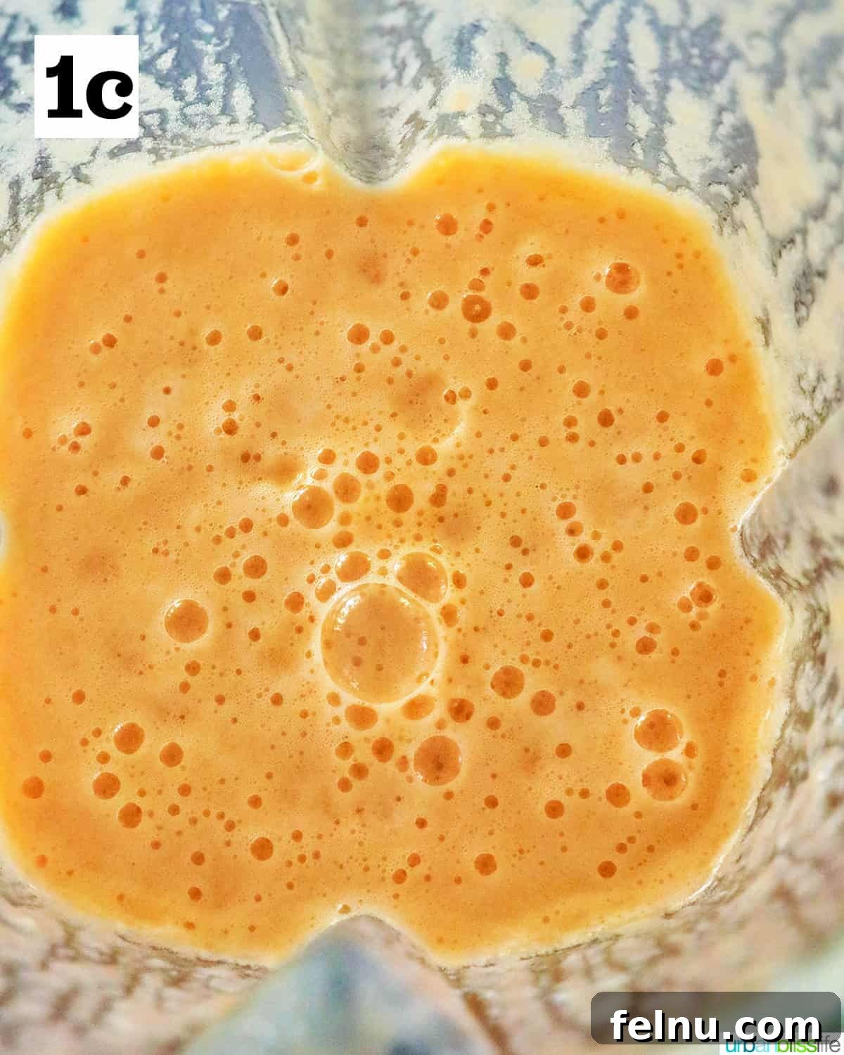 Blended cantaloupe margaritas in a blender.