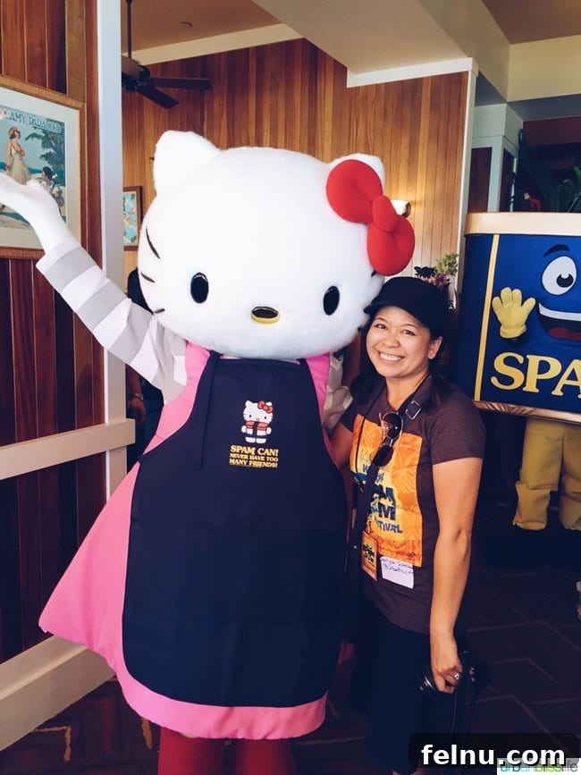 Author posing with Hello Kitty mascot, playfully photobombed by the SPAM Can mascot