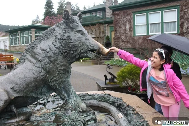 Victoria BC Family Fun: Top 5 Kid-Friendly Adventures 3 Girl touching boar statue at Butchart Gardens for good luck