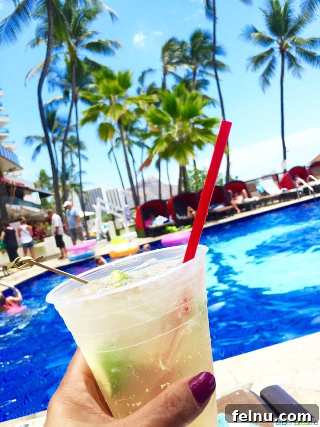 Outrigger Waikiki Beach Resort: Your Honolulu Home Away From Home 13 Enjoying a refreshing cocktail by the pool at the Outrigger Waikiki Beach Resort.