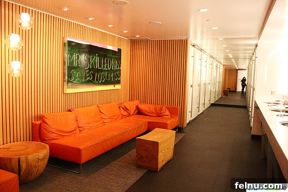 Vancouver BC's Cactus Club Cafe 5 hallway with orange couch and decorative wall art at Cactus Club Cafe coal harbour.