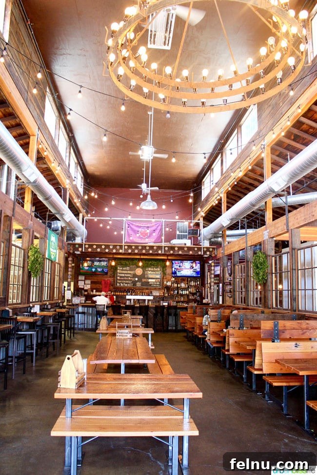 Sip and Stroll McMinnville 9 The bustling and spacious interior of The Grain Station, showcasing its unique atmosphere.