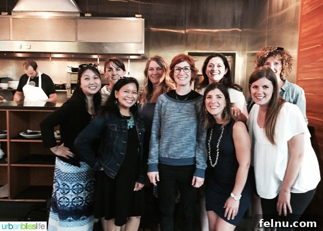 A group photo of bloggers enjoying happy hour at Lincoln Restaurant with Chef Jenn Louis.