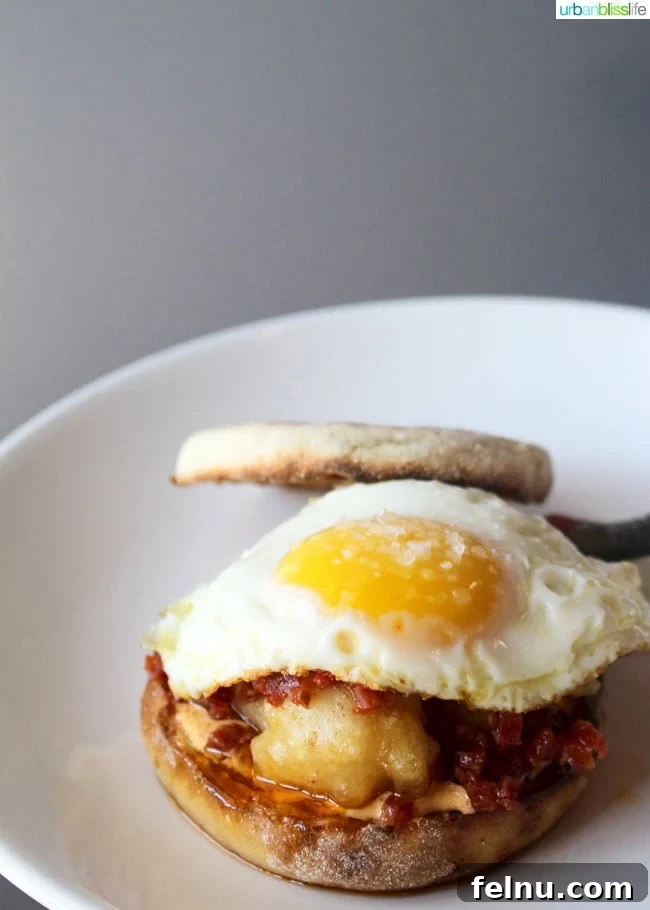 The English Muffin Breakfast Sandwich (for dinner) at Lincoln Restaurant, featuring Fontina in Carroza, egg, and sopresseta.