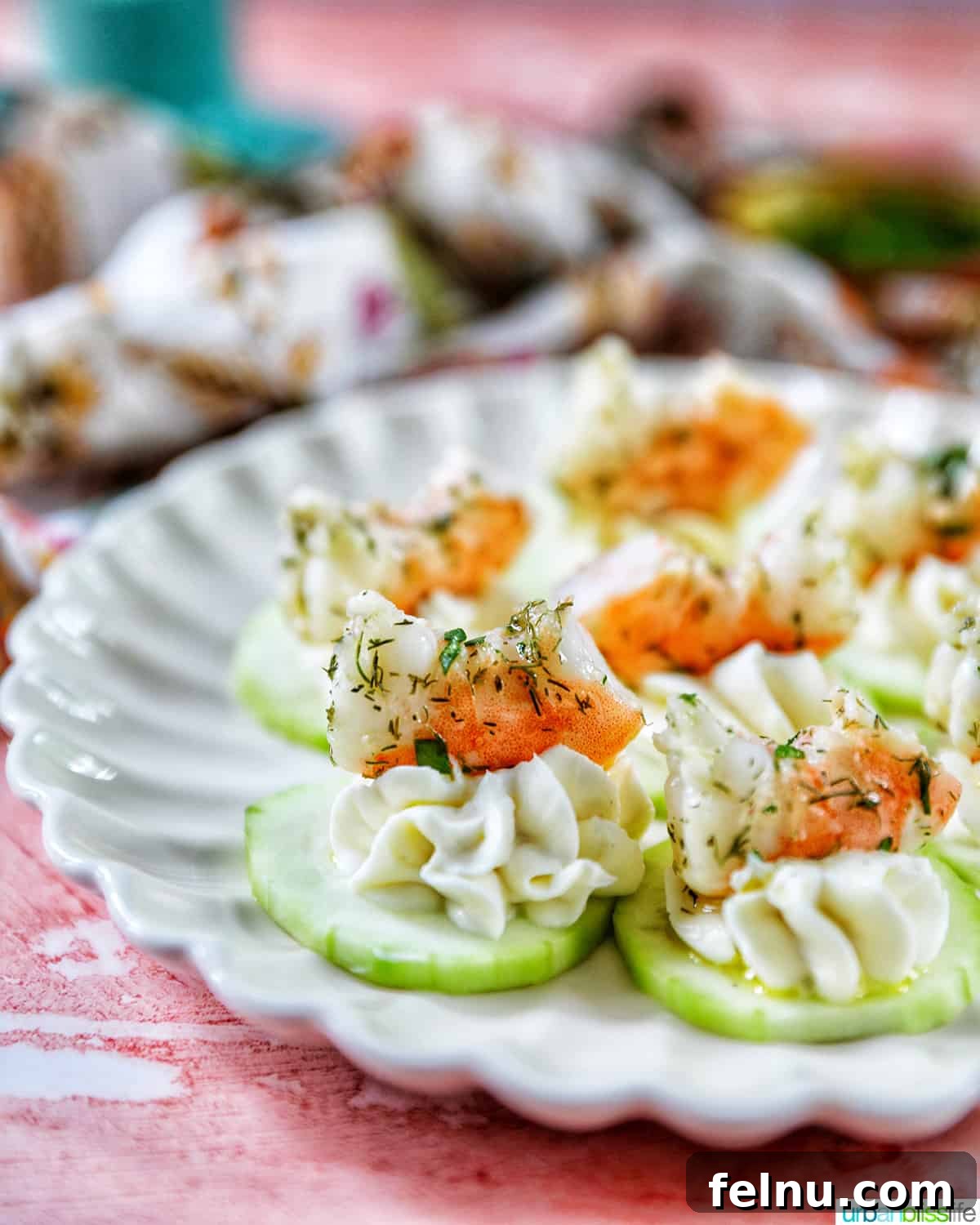 Crisp Cucumber Shrimp Delights 11 A crisp white plate adorned with a beautiful arrangement of shrimp canapes, ready to be served.
