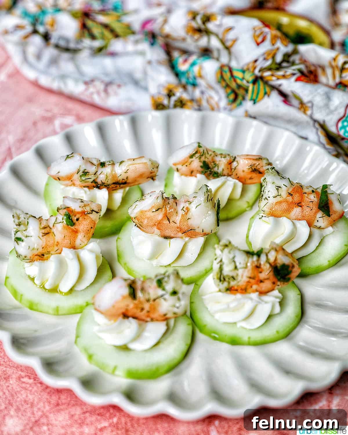 Crisp Cucumber Shrimp Delights 3 Close-up shot of perfectly assembled shrimp canapes on a delicate scalloped plate, showcasing their inviting presentation.