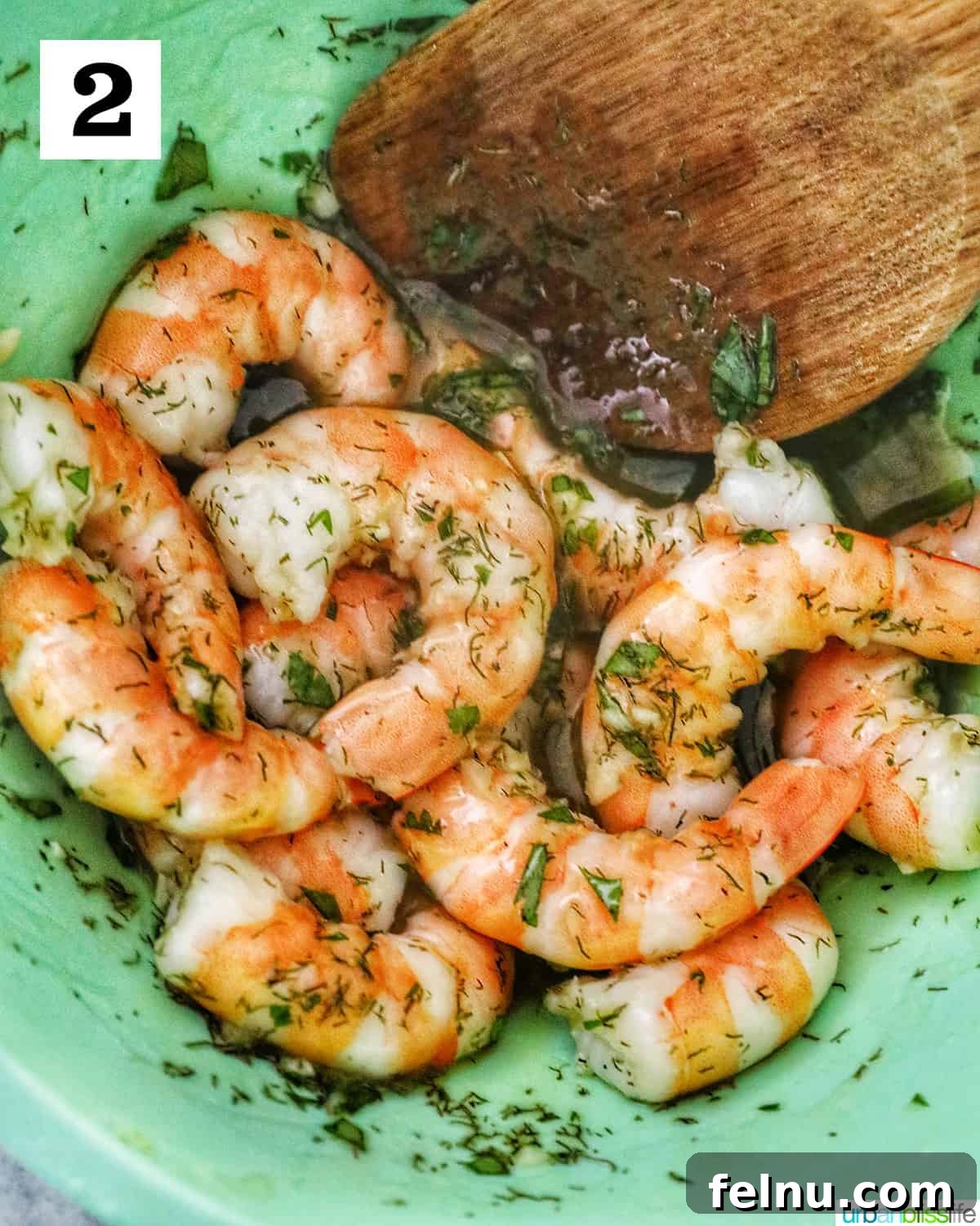 Crisp Cucumber Shrimp Delights 6 Pre-cooked shrimp being added to a vibrant herb and oil mixture in a green bowl for marination.