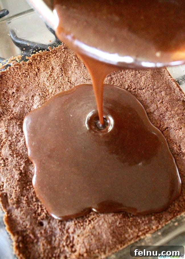 Salted Caramel Dark Chocolate Dream Bars 6 Pouring the chocolate caramel over the shortbread base