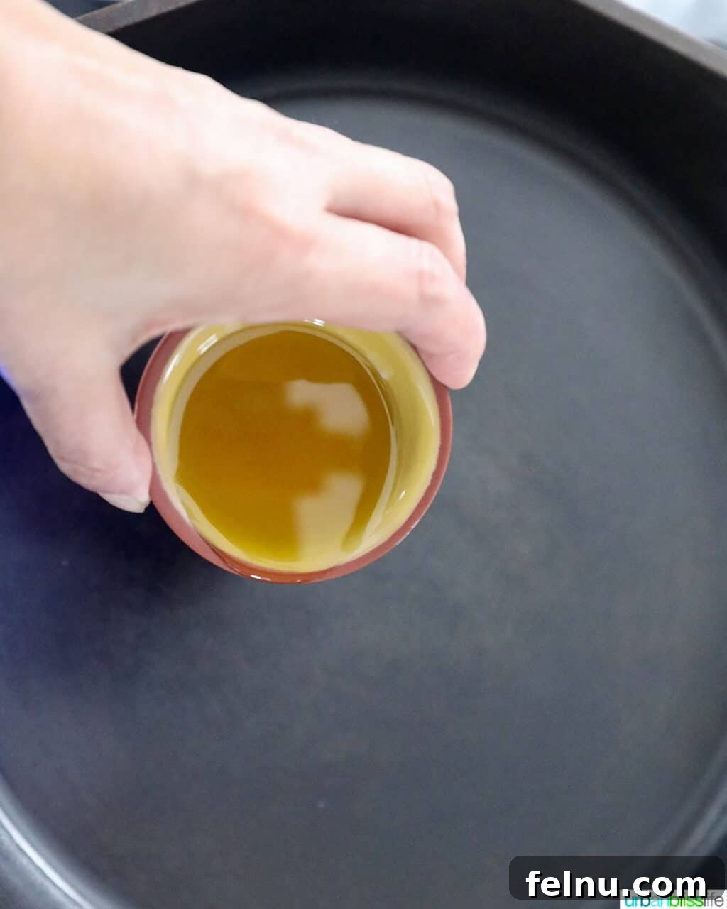 Tropical Coconut Lime Chicken 6 Olive oil being poured into a hot skillet, ready for cooking.