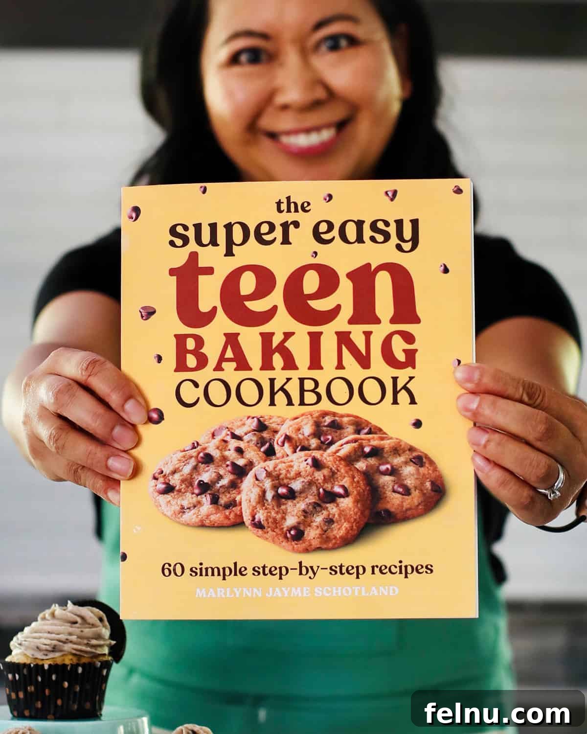 Baking Fundamentals 3 Author holding a copy of the Super Easy Teen Baking Cookbook