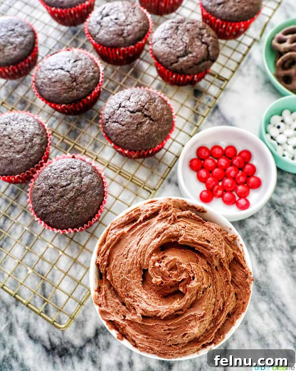Baking Fundamentals 5 Bowl of chocolate buttercream frosting with chocolate cupcakes and candy decorations
