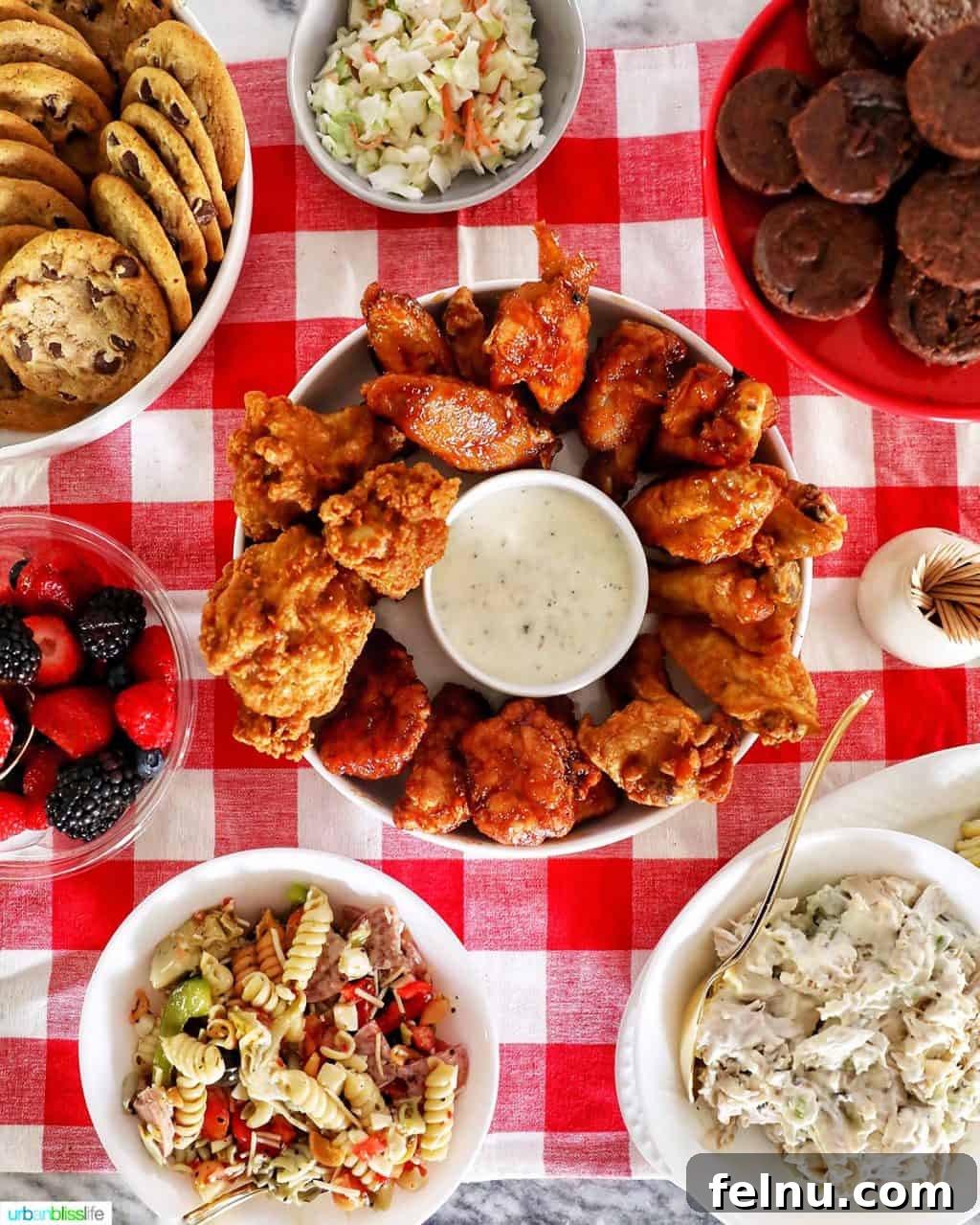 The Ultimate Football Feast: Delicious Finger Foods for Game Day 2 Tailgating food spread on a red checkered tablecloth