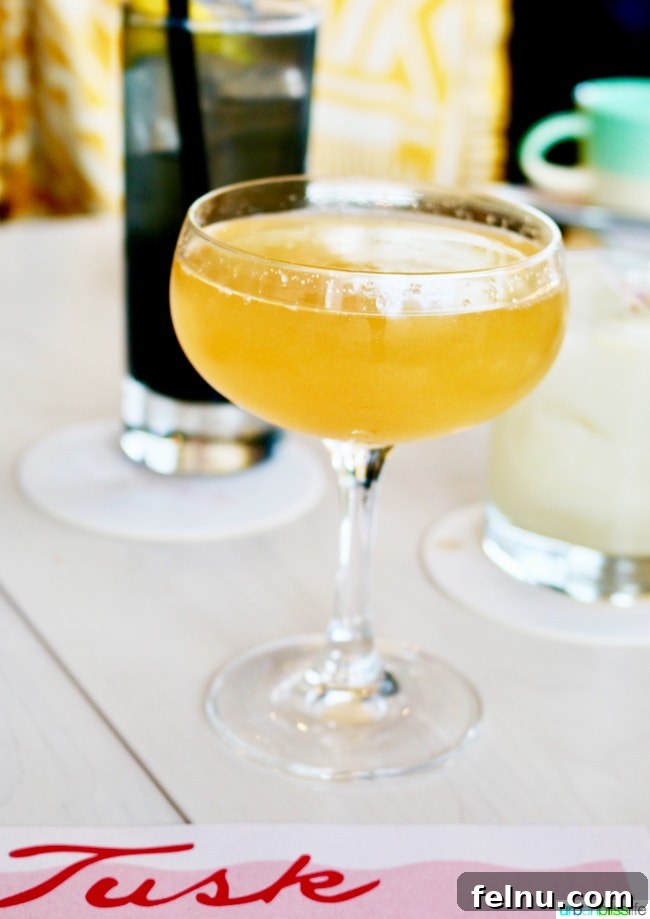 Middle Eastern Brunch Magic at Tusk 11 Tusk's Mimosa, garnished with a vibrant slice of grapefruit and known for its unique turmeric infusion, a modern twist on a classic.