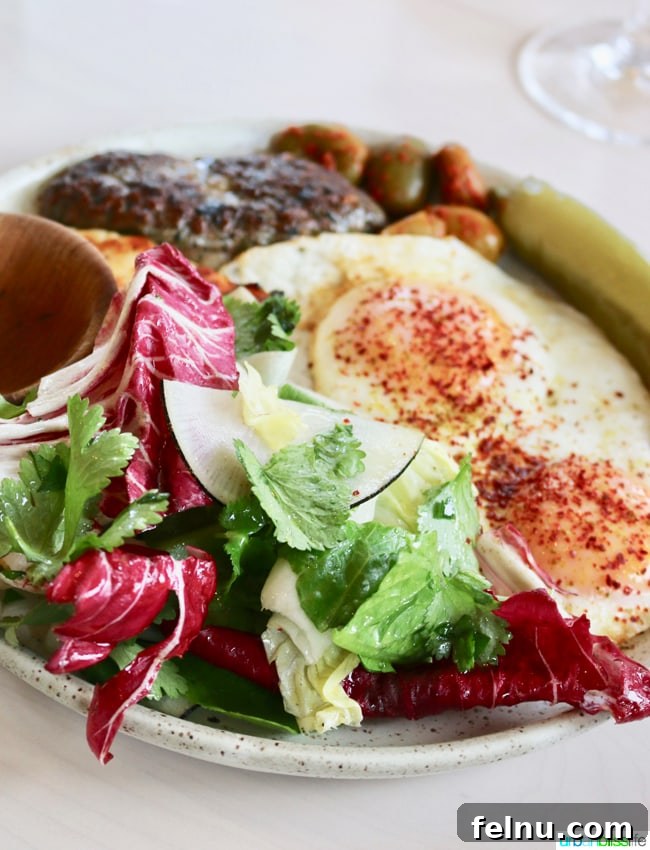 Middle Eastern Brunch Magic at Tusk 20 The Cypriot dish at Tusk, showcasing grilled halloumi cheese, a beef skewer, fried eggs, pickled pepper, and a refreshing herb salad.