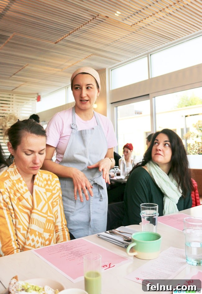 Middle Eastern Brunch Magic at Tusk 22 Pastry Chef Nora Antene smiling in the kitchen of Tusk Middle Eastern Restaurant, known for her delicious baked goods.