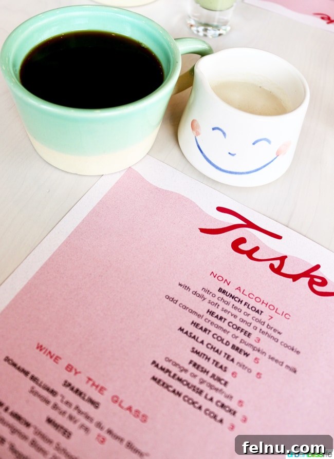 Middle Eastern Brunch Magic at Tusk 7 A delicate cup of coffee served in a distinct, artistic mug at Tusk Middle Eastern Restaurant, perfect for a cozy morning.
