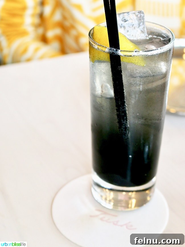 Middle Eastern Brunch Magic at Tusk 10 The Black Gold cocktail at Tusk, a dark and visually striking drink made with activated charcoal, served in an elegant glass.