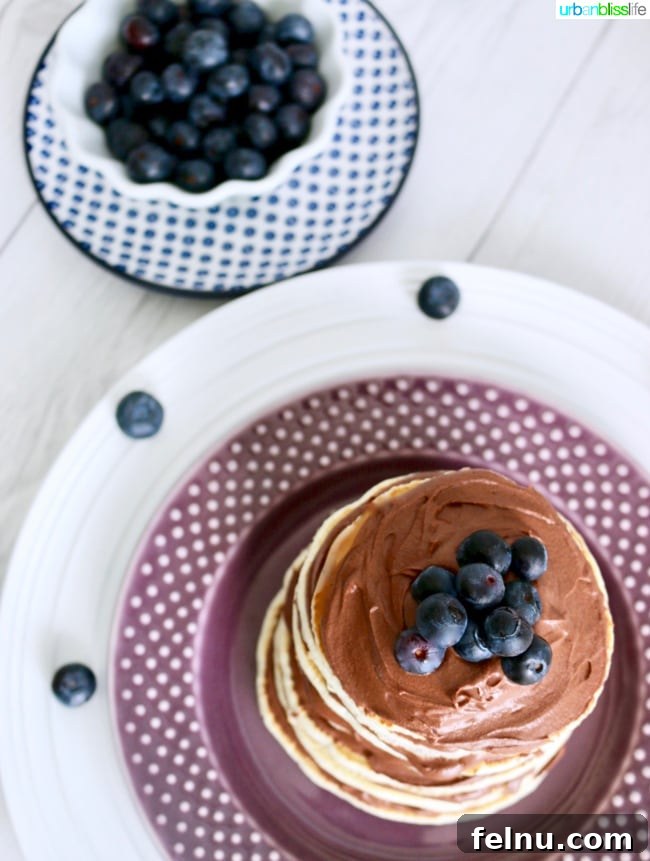 Rich Chocolate Pancake Towers with Pillowy Frosting 8 Pancake Cake Stacks with Dairy-Free Chocolate Frosting recipe on UrbanBlissLife.com