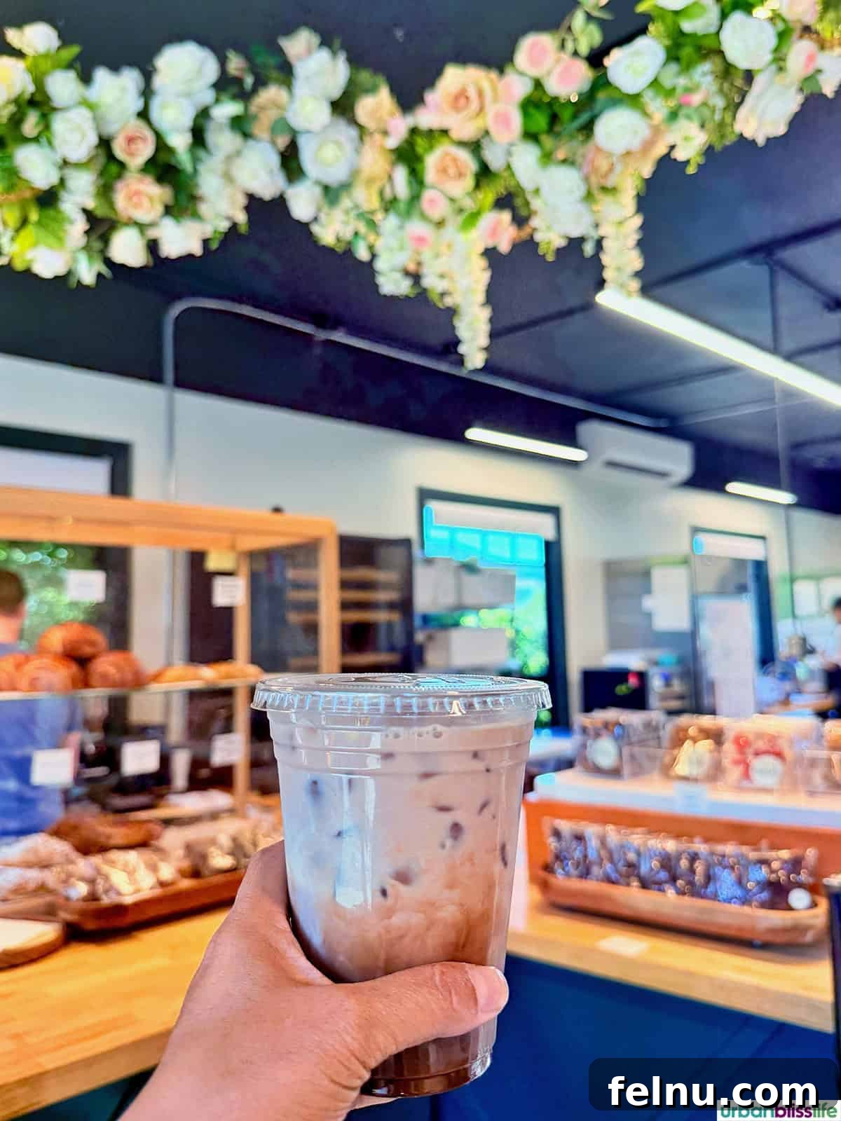 Hood River: Oregon's Adventure Capital 15 A hand holding a refreshing iced coffee beverage, a perfect pick-me-up from Edeske Patisserie in Hood River, Oregon.
