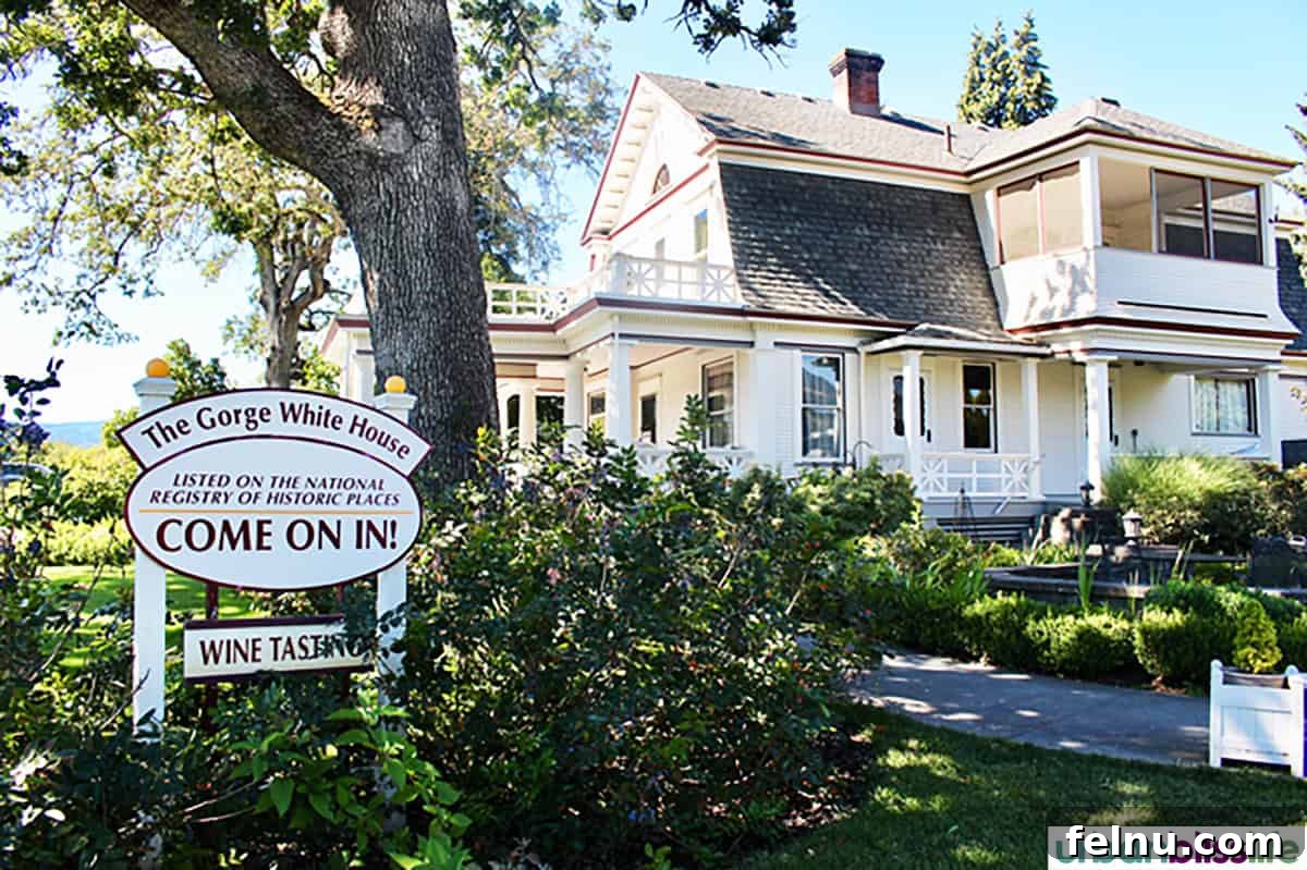 Hood River: Oregon's Adventure Capital 23 The charming exterior of The Gorge White House, nestled amidst lush greenery, a delightful spot to enjoy local ciders.