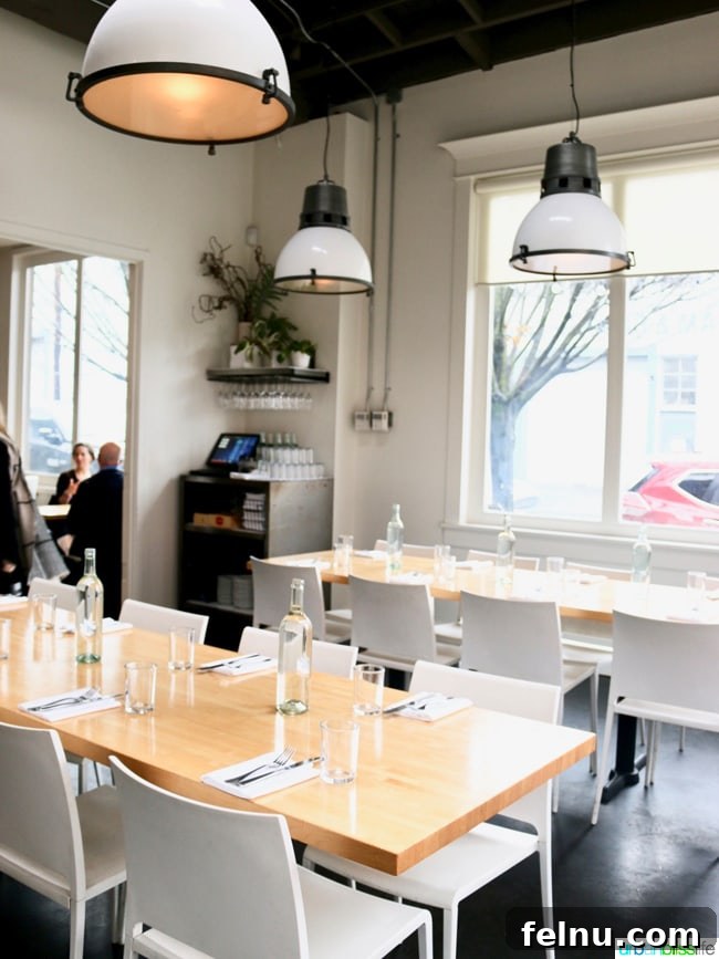 Olympia Provisions Unveils Handcrafted Landrauchschinken 8 Inviting interior of an Olympia Provisions dining room, showcasing their commitment to quality and atmosphere