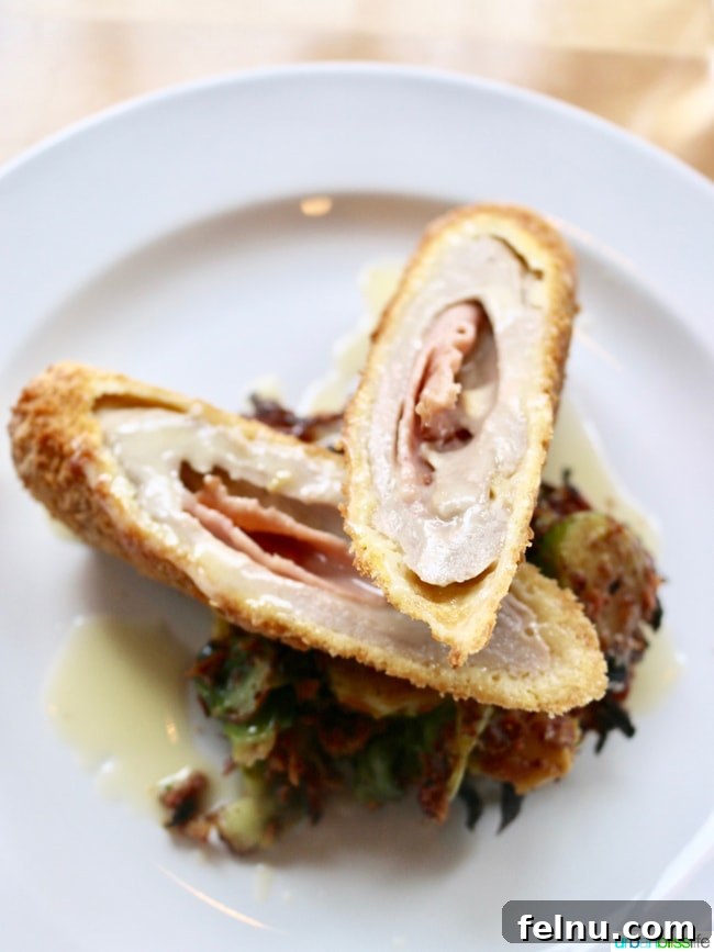 Olympia Provisions Unveils Handcrafted Landrauchschinken 7 Crispy Pork Roulade with Landrauchschinken, raclette, root vegetable rosti, and brussel sprouts