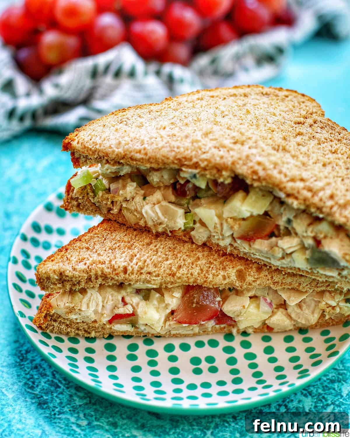 Dainty Chicken Salad Tea Bites 7 Stacked chicken salad tea sandwiches on a white plate