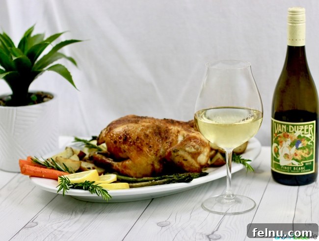 Classic Lemon Herb Roasted Chicken and Veggies 14 A landscape view of white wine and Lemon Herb Roasted Chicken