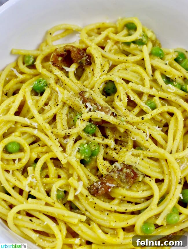 Golden Turmeric Pasta with Smoky Bacon and Sweet Peas 3 A close-up of turmeric pasta in a bowl, highlighting the rich yellow hue.
