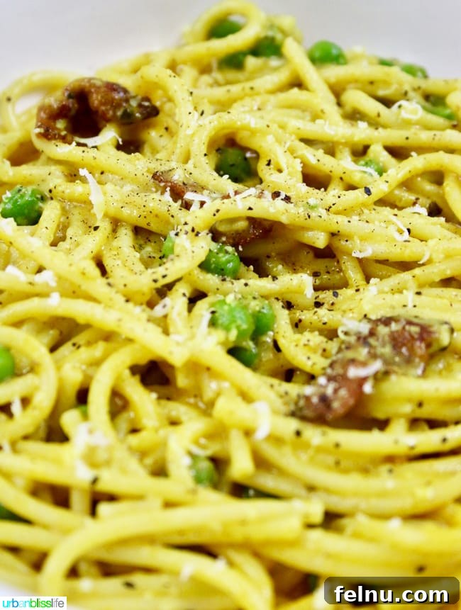 Golden Turmeric Pasta with Smoky Bacon and Sweet Peas 4 A serving of Turmeric Pasta with Bacon and Peas, a hearty lunch or dinner.