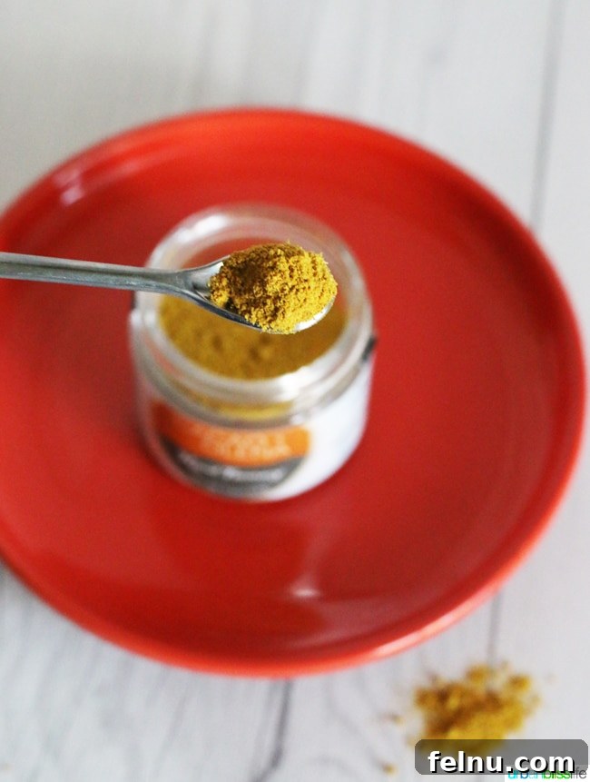 Golden Turmeric Pasta with Smoky Bacon and Sweet Peas 6 Close-up of turmeric powder, ready for culinary or medicinal use.