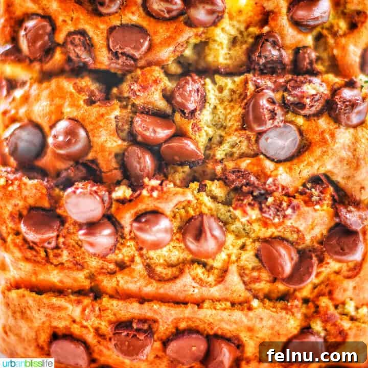 A close-up shot of chocolate chip banana bread, showcasing its moist texture and abundance of chocolate chips.