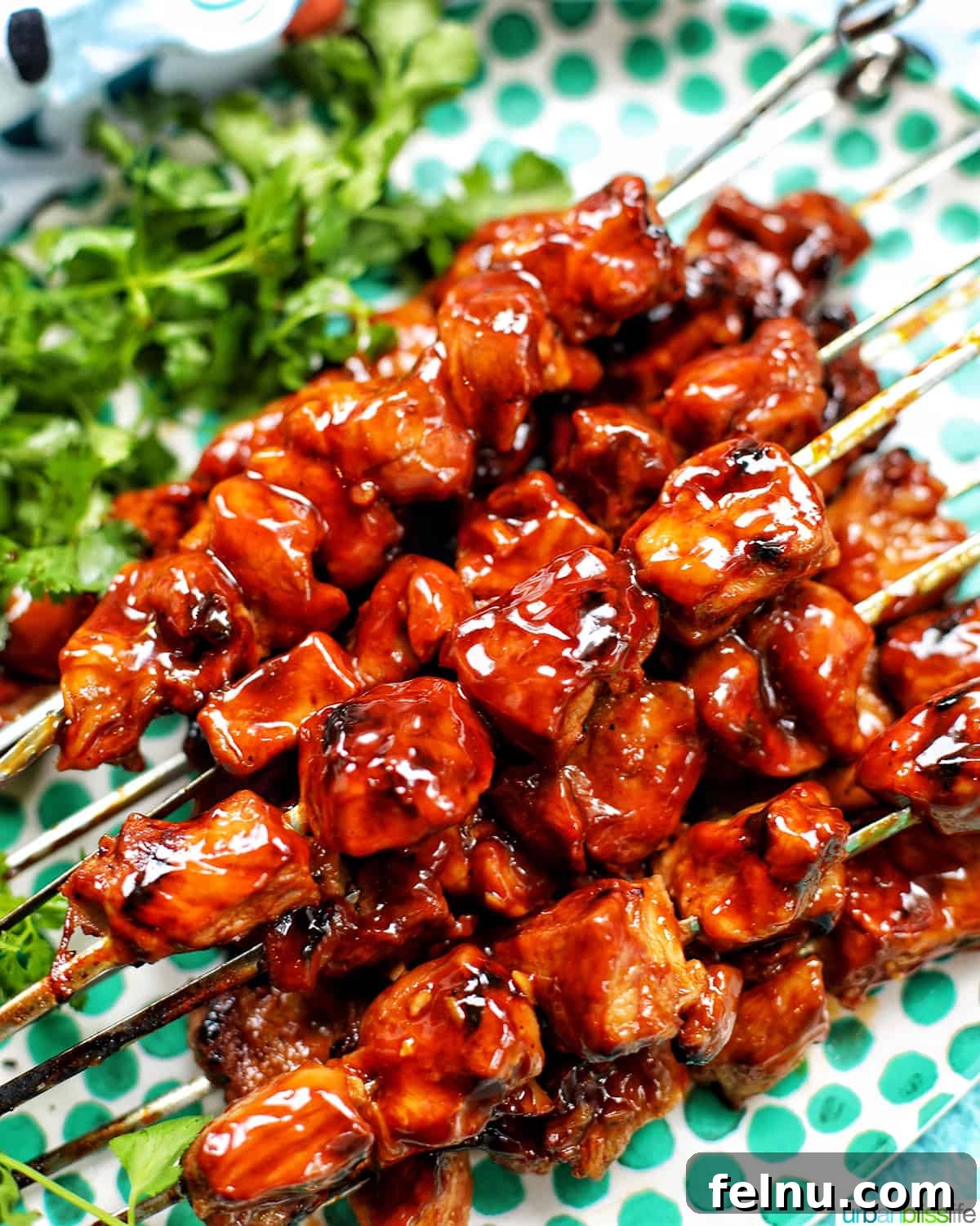 Sip, Sizzle, Savor: Wines That Perfect Your BBQ 6 A tantalizing closeup of Filipino BBQ pork skewers, glistening with marinade and adorned with fresh cilantro leaves, a culinary delight.