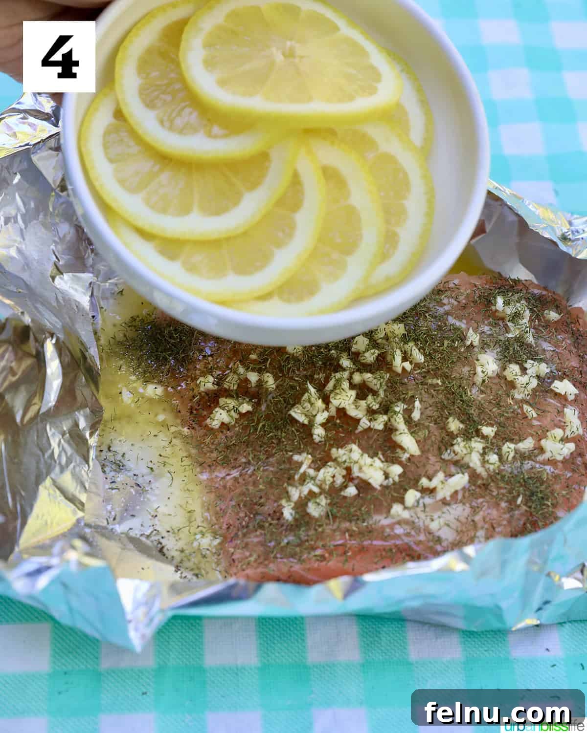 Zesty Lemon Herb Salmon Delight 9 Lemon slices above garlic buttered salmon in foil.