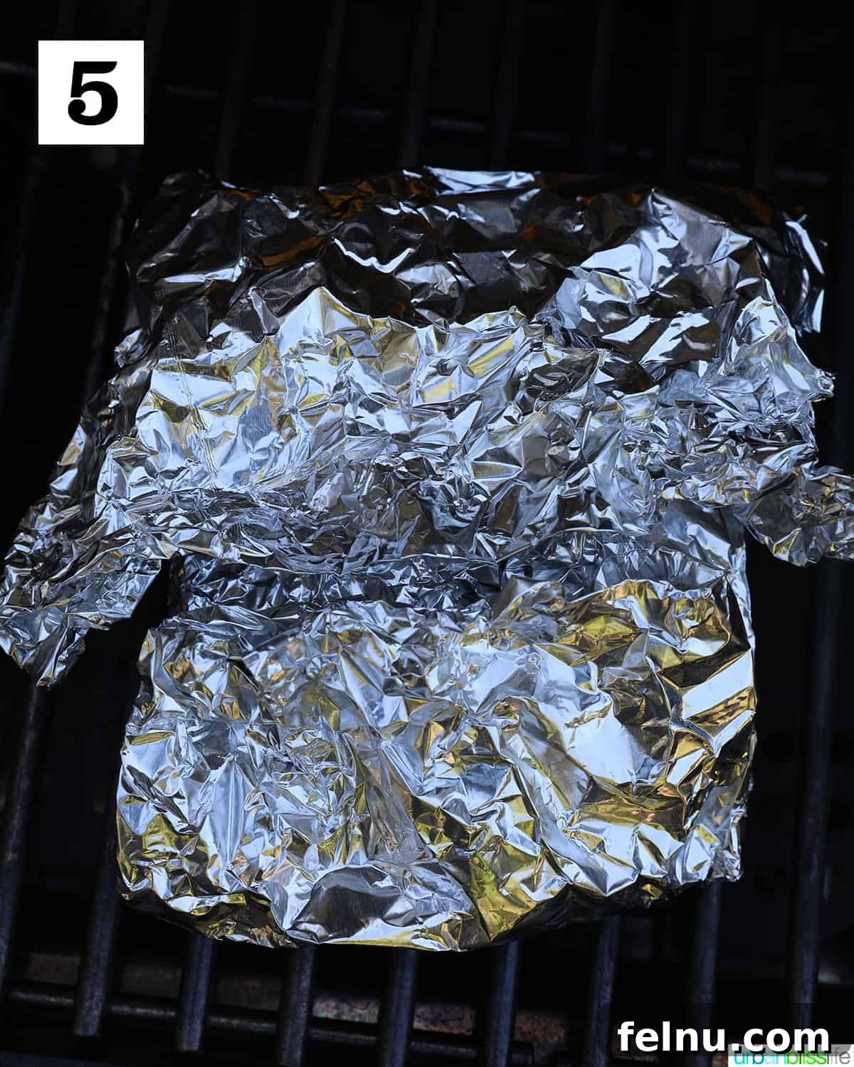 Zesty Lemon Herb Salmon Delight 10 Foil with salmon on the grill.