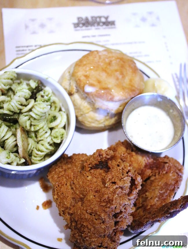 Party Downtown: Eugene, Oregon's Must-Visit for Exceptional Dining and Catering 7 Delicious fried chicken served with biscuit and pasta salad at Party Downtown in Eugene, Oregon. Food Travel Bliss on UrbanBlissLife.com