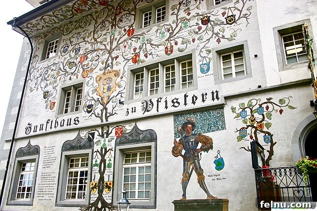 Lucerne Family Fun: Top Activities with Kids 8 An artistic facade of a building in Lucerne, showcasing intricate murals and ornate decorations.