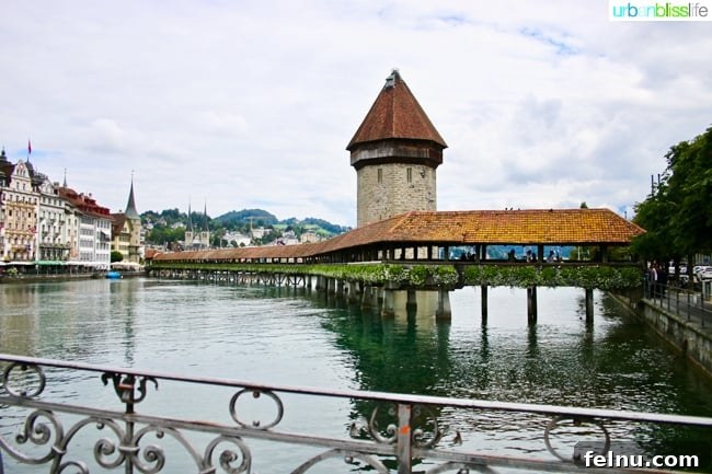 Lucerne Family Fun: Top Activities with Kids 4 A wide-angle view of the Chapel Bridge in Lucerne, showcasing its iconic structure spanning the Reuss River.