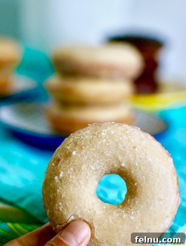 A close-up of a glazed cinnamon sugar donut, showcasing its texture and deliciousness.